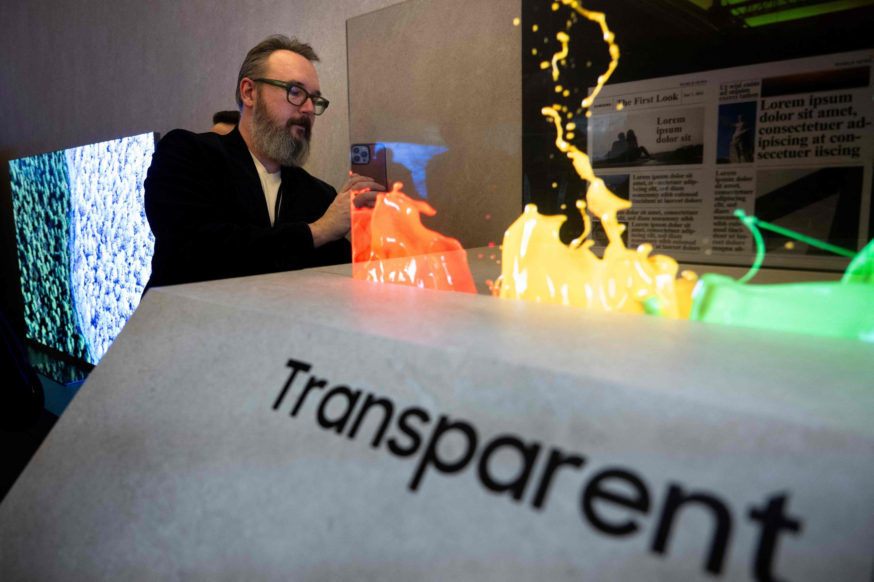 309352 A person looks at a transparent microled screen during the Samsung First Look preview at the Caesars Palace Resort a pre-show for this week's Consumer Electronics Show (CES), in Las Vegas, Nevada, U.S., Jan. 7, 2024. (AFP Photo)