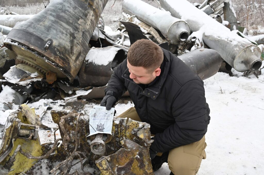 A Ukrainian prosecutor's office expert inspects remains of a missile used during an attack on Kharkiv, Ukraine, Jan. 6, 2024. (AFP Photo)