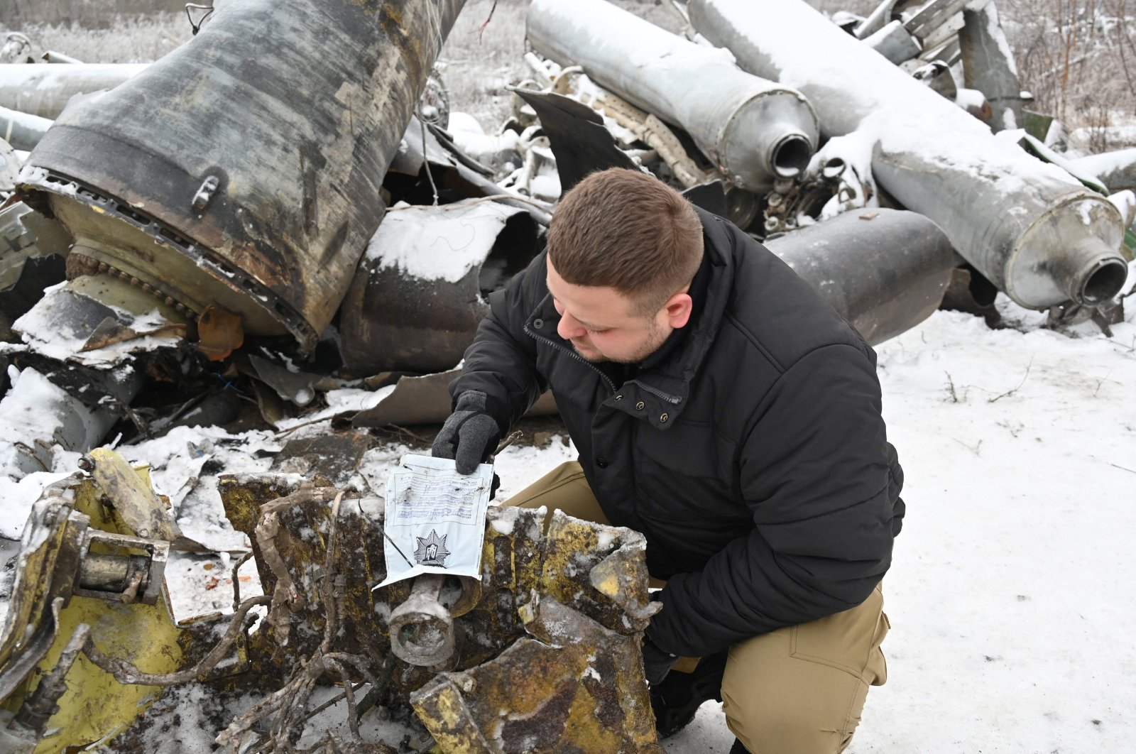 A Ukrainian prosecutor's office expert inspects remains of a missile used during an attack on Kharkiv, Ukraine, Jan. 6, 2024. (AFP Photo)