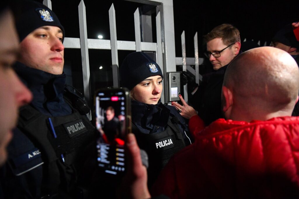 Police officers stand guard as opposition supporters protest against the detention of two former ministers in Warsaw, Poland, Jan. 9, 2024. (EPA Photo)