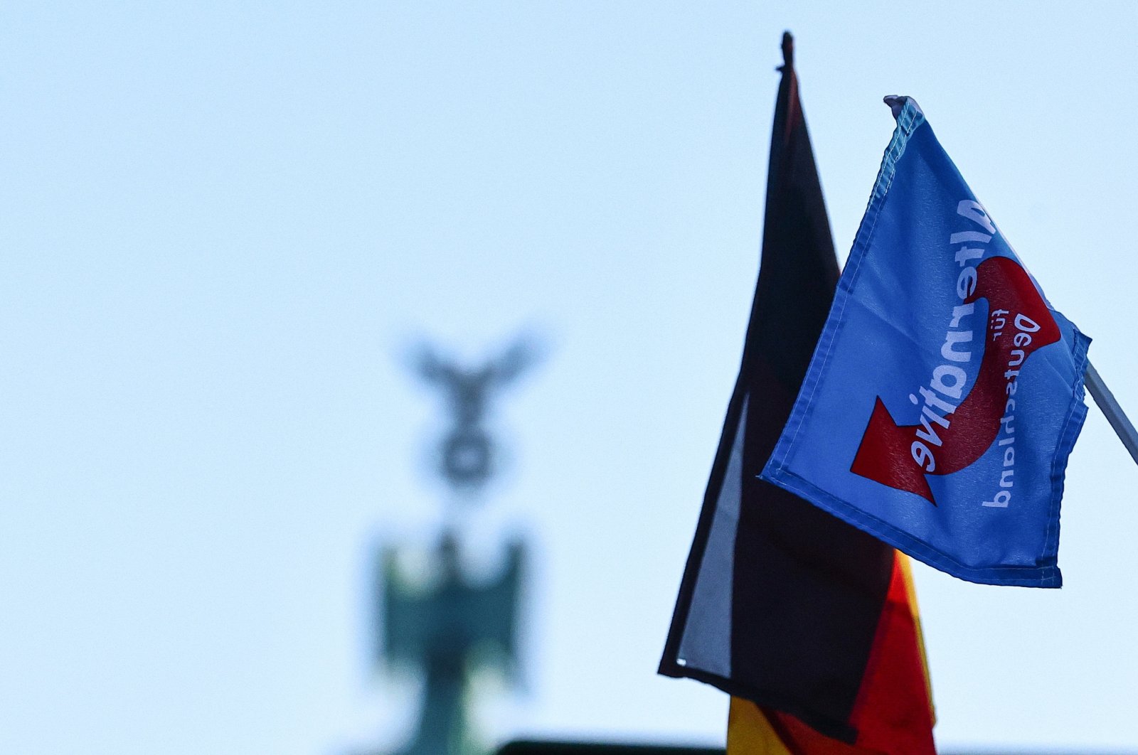 A flag supporting far-right party Alternative for Germany (Alternative fuer Deutschland, AfD) and a German flag hang on a farmer's truck with the Brandenburg Gate in the background during a nationwide farmers' strike, in Berlin, Germany, Jan. 8, 2024. (EPA Photo)