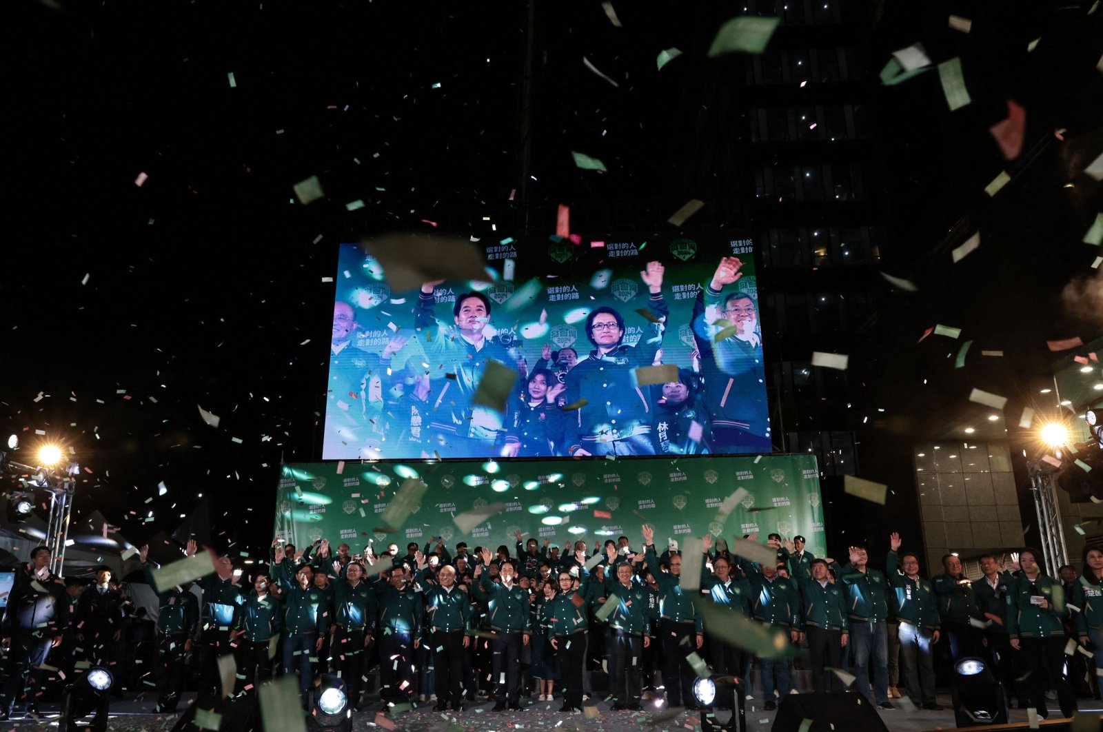 A display shows Taiwan's President-elect Lai Ching-te (L) and his running mate Hsiao Bi-khim attending a rally outside the headquarters of the Democratic Progressive Party (DPP) in Taipei on Jan. 13, 2024. (AFP Photo)