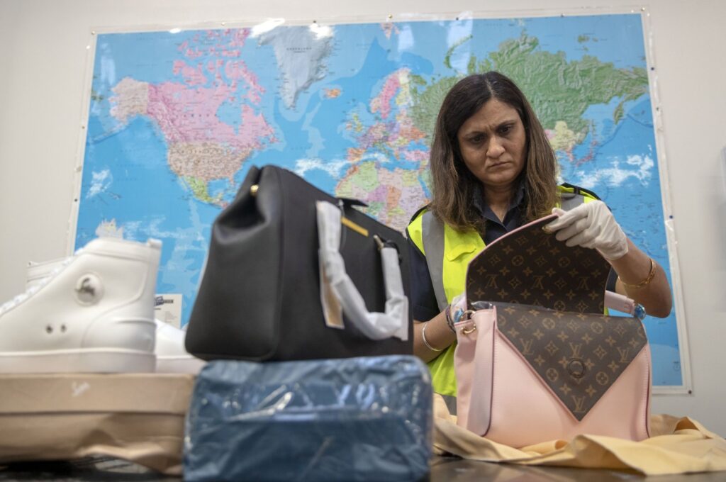 A Border Force officer uses an x-ray machine to search through mail for counterfeit items, at a facility near Slough, Berkshire, U.K., Nov. 28, 2018. (Reuters Photo)