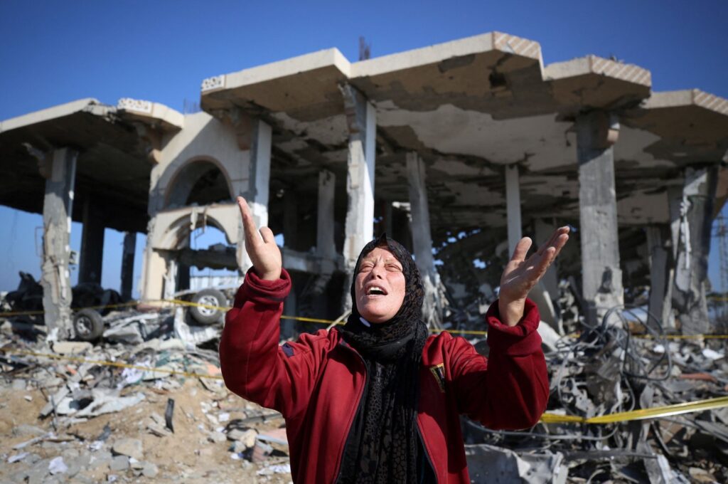 A Palestinian woman reacts in front of a destroyed building in the al-Maghazi refugee camp in central Gaza, Palestine, Jan. 16, 2024. (AFP Photo)