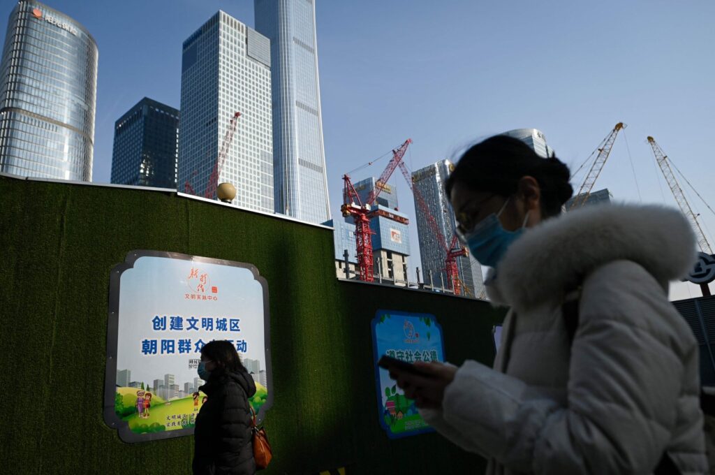 People walk past a construction site at the Central Business District (CBD) in Beijing, China, Jan. 16, 2024. (AFP Photo)