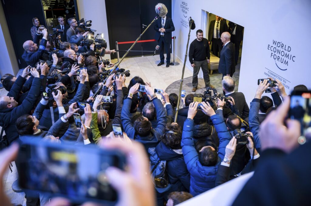 Ukrainian President Volodymyr Zelenskyy stands next to World Economic Forum Founder and Executive Chairman Klaus Schwab in front of the media during the 54th annual meeting of the WEF in Davos, Switzerland, Jan. 16, 2024. (AP Photo)