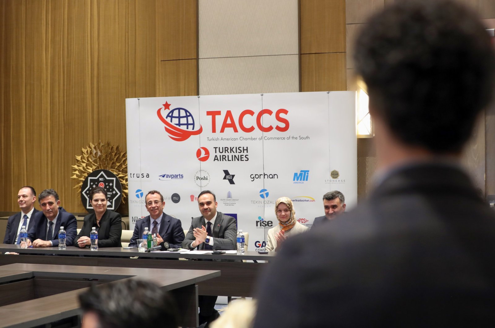 Industry and Technology Minister Mehmet Fatih Kacır (C) applauds during a business event in Orlando, Florida, U.S., Jan. 17, 2024. (AA Photo)