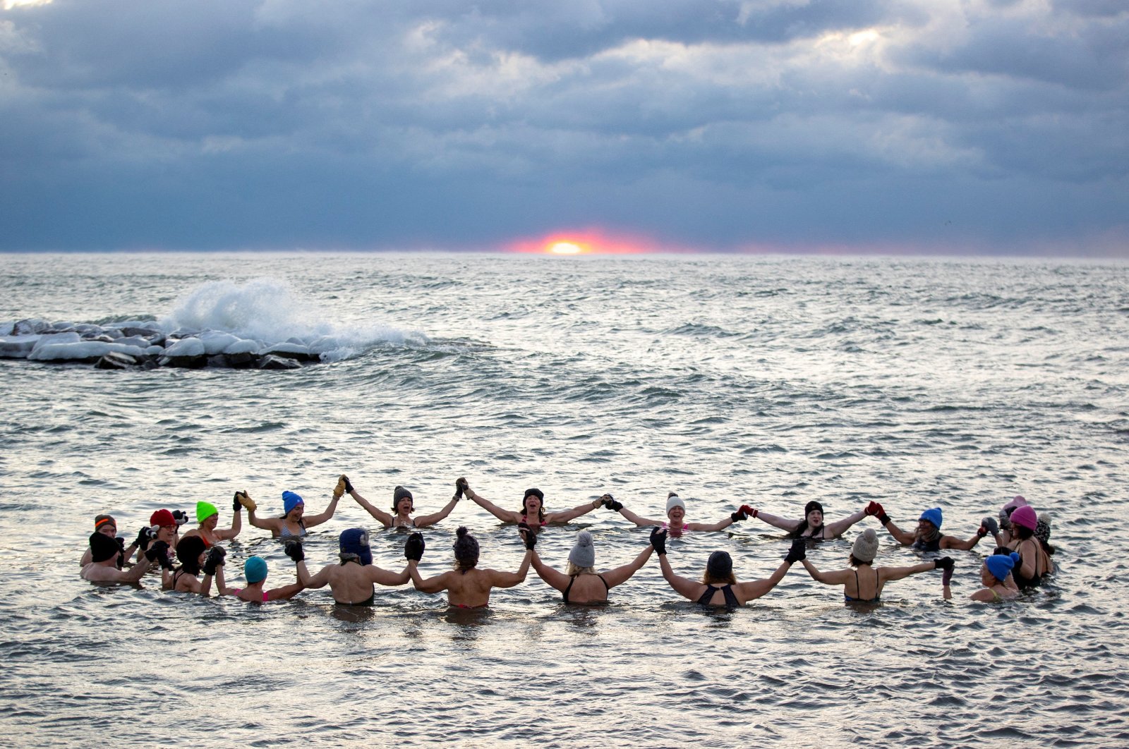 A group consisting mostly of women, who call themselves "The Endorphins," gather for a sunrise swim in the chilly waters of Lake Ontario during freezing temperatures in Toronto, Ontario, Canada. Jan. 17, 2024.  (Reuters Photo)