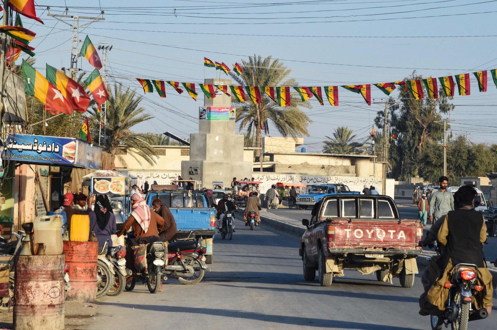 Commuters ride along a street at Panjgur district in Balochistan province on Jan. 17, 2024. (AFP Photo)