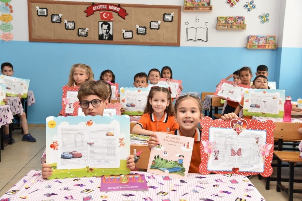 Children are seen happy holding their report cards for the academic year, Istanbul, Türkiye, Jan. 19, 2024. (IHA Photo)