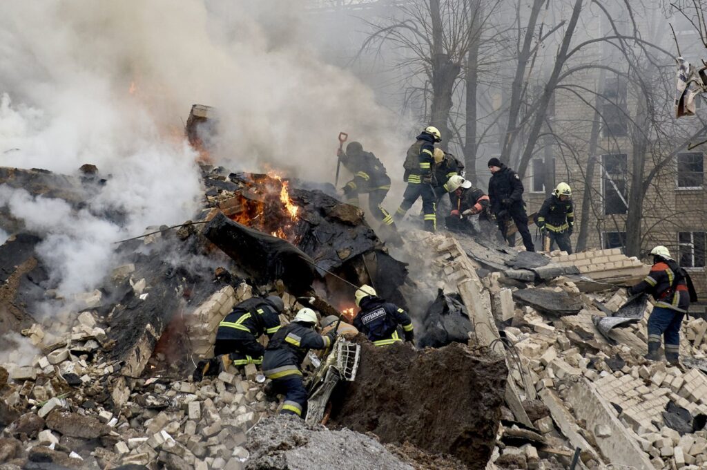 Ukrainian rescuers work at the site of a rocket attack in Kharkiv, Ukraine, Jan. 23, 2024.