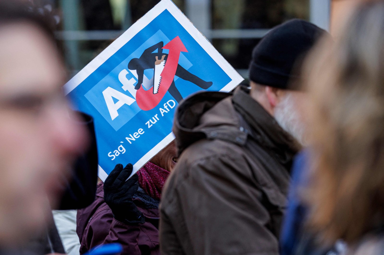 A person holds up a placard reading "Say Nope to AFD" as she takes part in a demonstration against racism and far-right politics, in Erfurt, eastern Germany on Jan. 20, 2024. (AFP Photo)