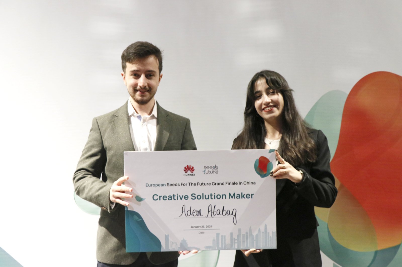 Turkish student Adem Atabağ (L) receives the "Creative Solution Producer" award, Beijing, China, Jan. 24, 2023. (AA Photo)