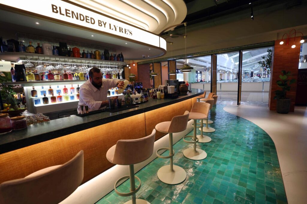 Lebanese bartender Hadi Ghassan prepares a drink behind the counter at "Meraki Riyadh," a pop-up bar offering non-alcoholic bellinis and spritzes, served in chilled cocktail glasses, in Riyadh on Jan. 23, 2024. (AFP Photo)
