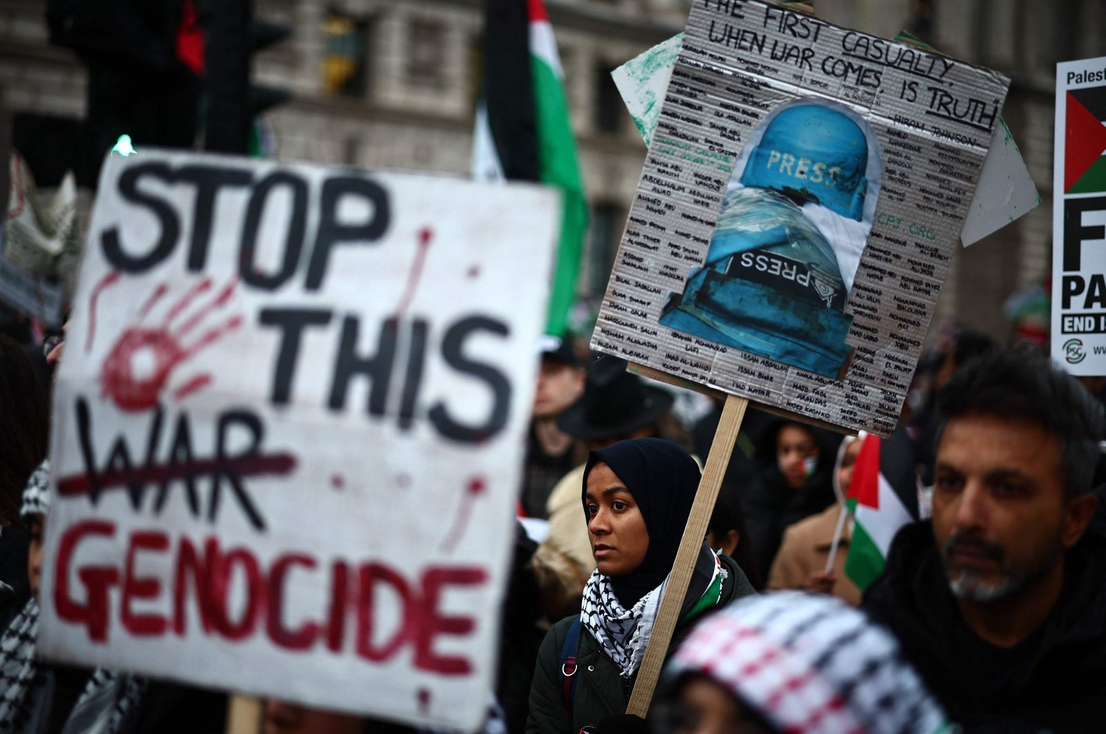 Pro-Palestinian activists and supporters carry placards, including a sign featuring names of killed and wounded journalists, London, U.K., Jan. 13, 2024. (AFP Photo)