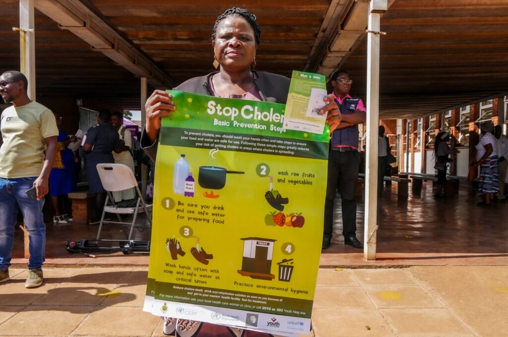 A woman displays a poster informing against cholera during the launch of a cholera vaccination program at the Kuwadzana Polyclinic in Kuwadzana, Zimbabwe, Jan. 29, 2024. (EPA Photo)