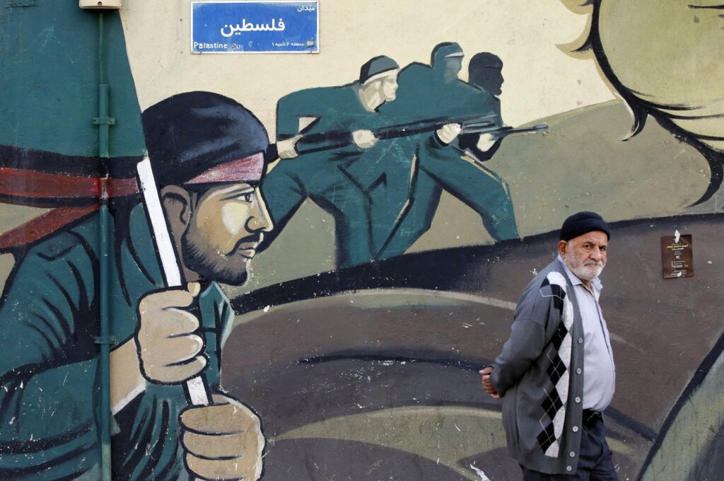 An Iranian man walks past a mural of Iranian revolutionary guard soldiers, Tehran, Iran, Jan. 30, 2024. (EPA Photo)