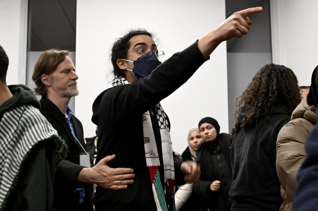 A young man gestures during a ceremony to commemorate the 2017 mosque shooting, in Quebec City, Canada, Jan. 29, 2024. (AP Photo)