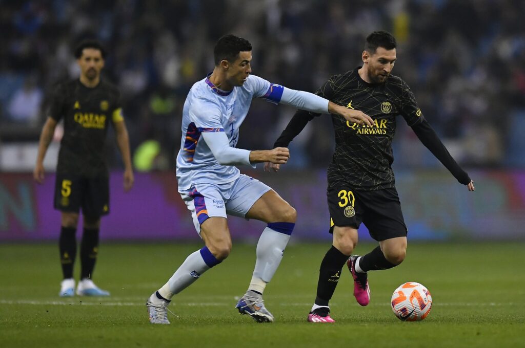 Ex-PSG star Lionel Messi (R) and Riyadh XI's Cristiano Ronaldo fight for possession during the friendly match at King Fahd International Stadium, Riyadh, Saudi Arabia, Jan. 19, 2023. (Getty Images Photo)