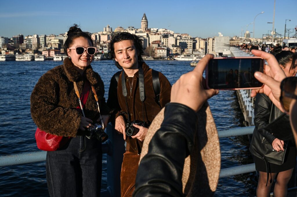 Tourists pose for a photo in the famous Eminönü neighborhood, in Istanbul, Türkiye, Jan. 5, 2024. (AA Photo)