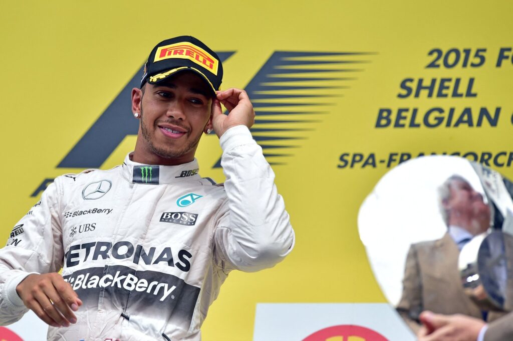 Mercedes AMG Petronas F1 Team's British driver Lewis Hamilton looks at the trophy as he celebrates winning on the podium at the Spa-Francorchamps circuit after the Belgian Formula One Grand Prix, in Spa, Belgium, Aug. 23, 2015. (AFP File Photo)