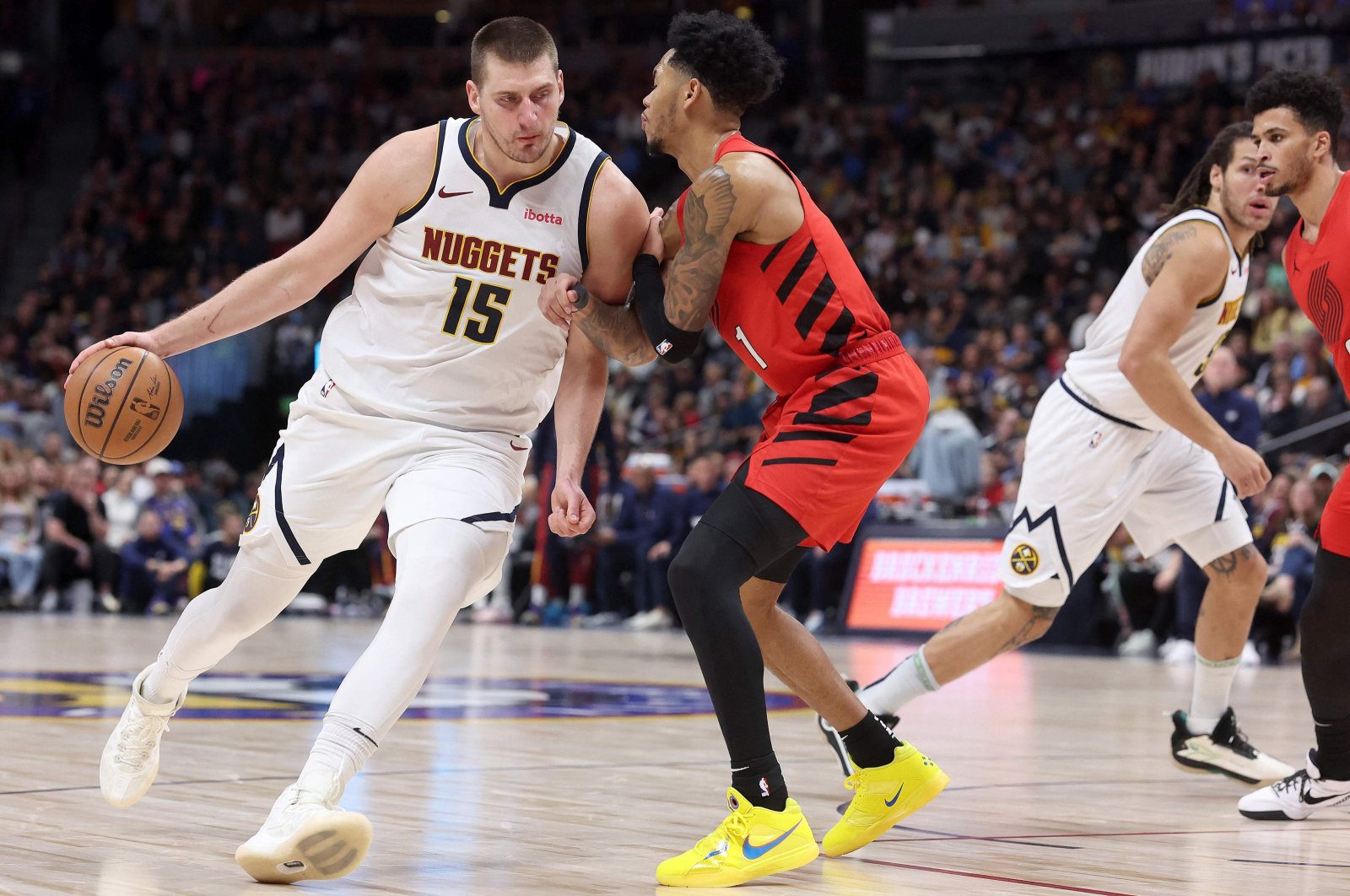 Denver Nuggets' Nikola Jokic (L) drives against Portland Trail Blazers' Anfernee Simons in the fourth quarter at Ball Arena, Denver, Colorado, U.S., Feb. 4, 2024. (AFP Photo)