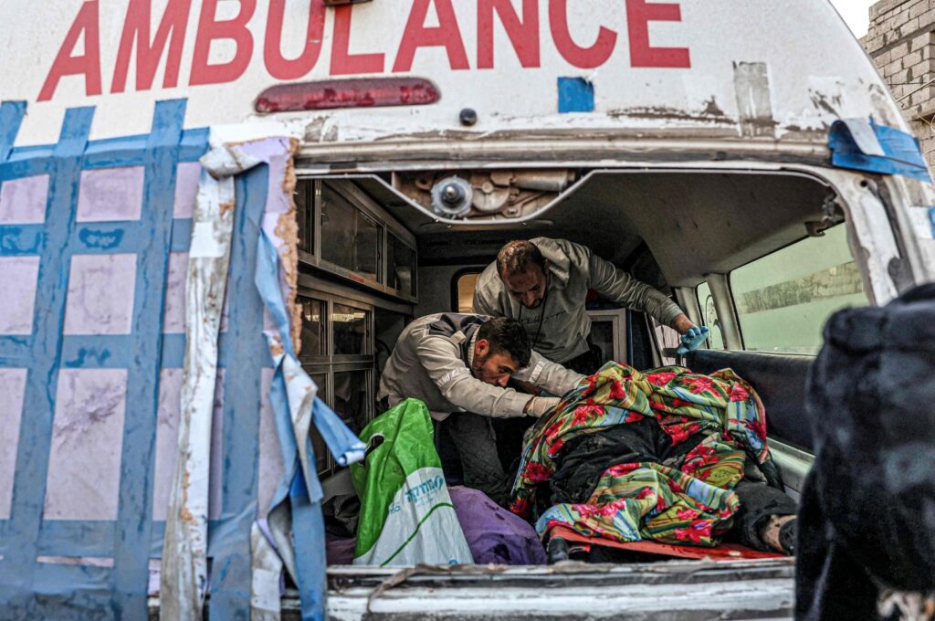 Palestinian paramedics recover to an ambulance the remains of bodies rescued from a wrecked car following Israeli bombardment in Rafah in the southern Gaza Strip on Feb. 6, 2024. (AFP Photo)