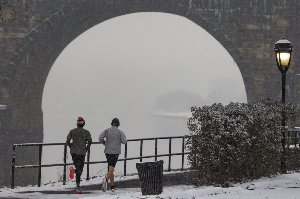 Joggers run along Kelly Drive in Philadelphia, Pennsylvania, U.S., Jan. 19, 2024. (AP Photo)