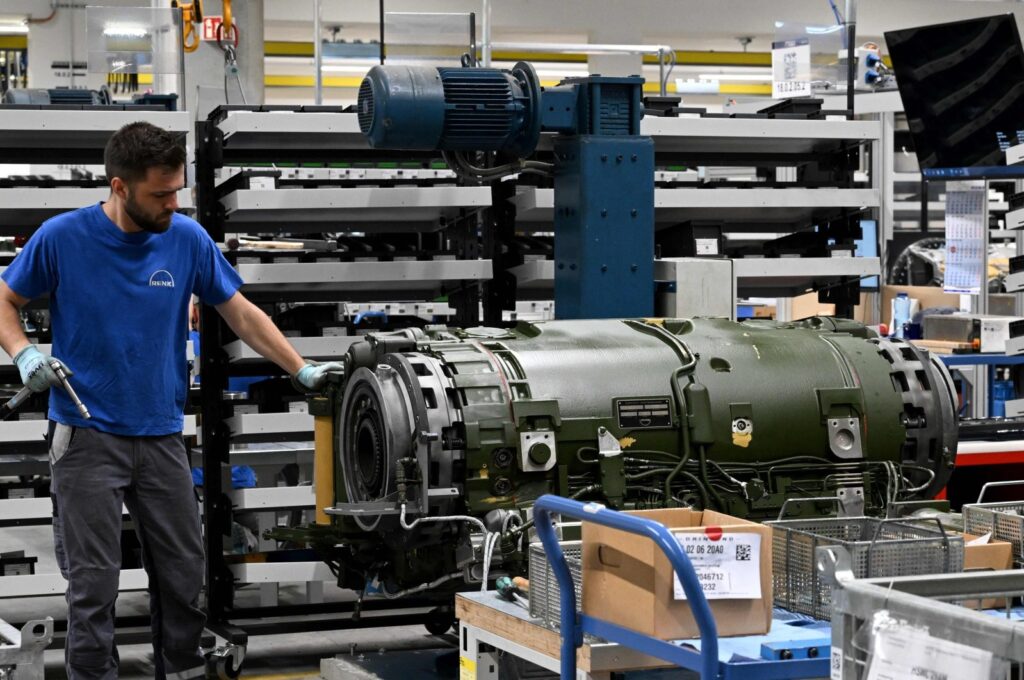 An employee works on a tank gearbox in an assembly hall of the German gear manufacturing company Renk, Augsburg, Germany, May 8, 2023. (AFP Photo)