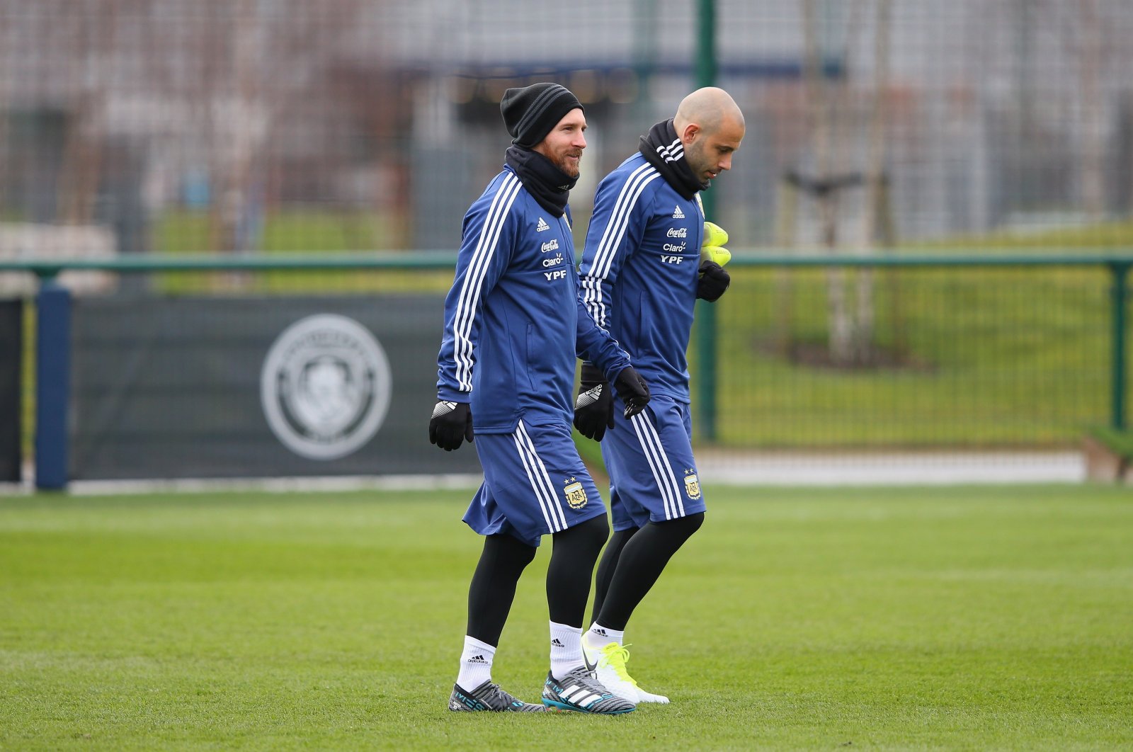 Argentina's Lionel Messi (L) walks out with Javier Mascherano during a training session at Manchester City Football Academy, Manchester, U.K., March 20, 2018. (Getty Images Photo)