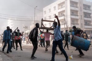 Protesters shout slogans and collect barrels and tables to burn during clashes with police in Dakar, Senegal, Feb. 9, 2024. (AFP Photo)