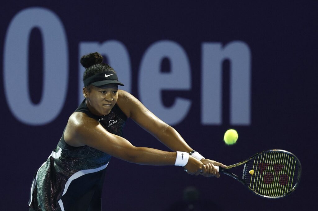 Japan's Naomi Osaka in action in the round of 32 match against Croatia's Petra Martic during their women's singles tennis match at the Qatar WTA Open at Khalifa International Tennis and Squash Complex, Doha, Qatar, Feb. 13, 2024. (AFP Photo)