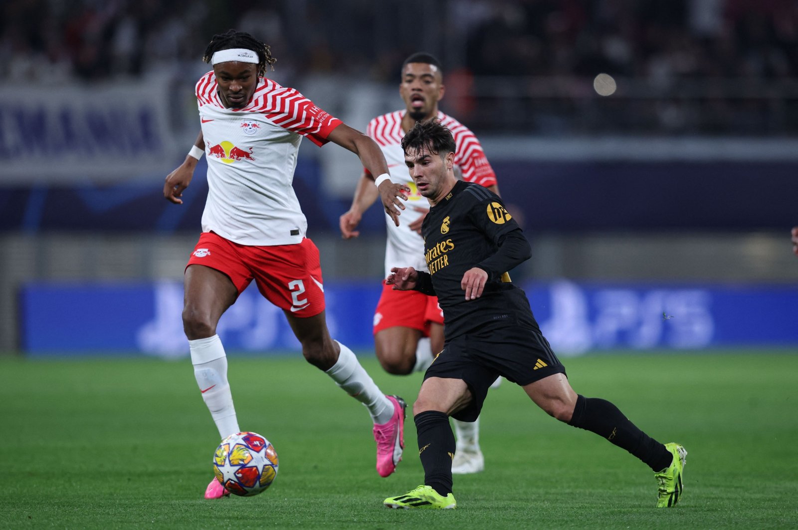 Real Madrid's Brahim Diaz (R) and Leipzig's Mohamed Simakan vie for the ball during the UEFA Champions League Round of 16, first-leg football match, Leipzig, Germany, Feb. 13, 2024. (AFP Photo)