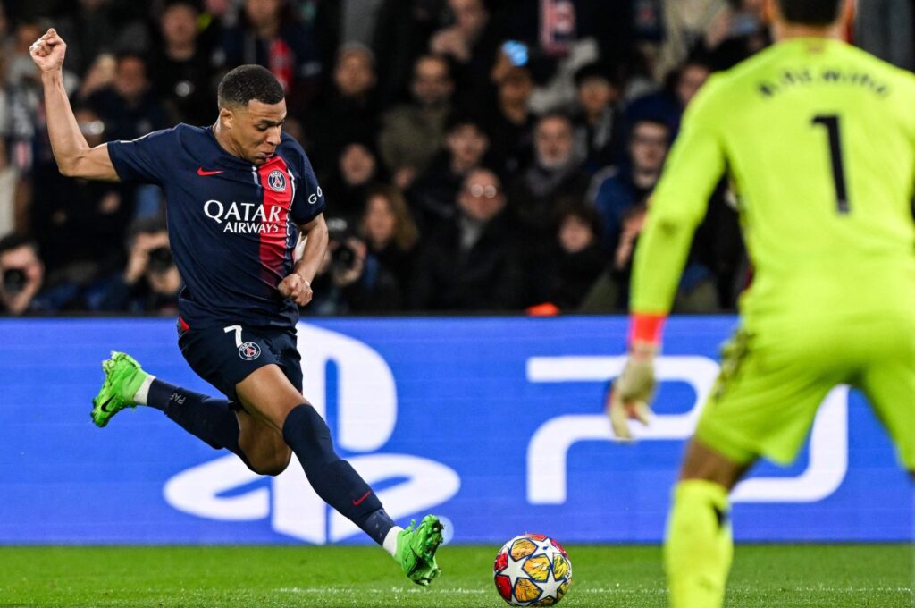 PSG's Kylian Mbappe (L) kicks the ball next to Real Sociedad's Alex Remiro during the UEFA Champions League round of 16 first leg football match at the Parc des Princes Stadium, Paris, France, Feb. 14, 2024. (AFP Photo)