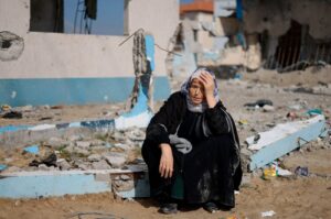 A woman rests next to a damaged building in Rafah, southern Gaza Strip, Palestine, Feb. 15, 2024. (Reuters Photo)