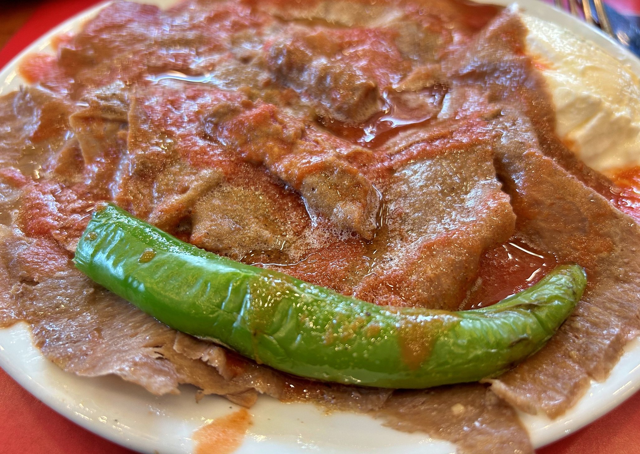 315243 Iskender Kebab, features thin slices of meat on hot pide covered in tomato sauce and yogurt, offering a decadent and flavorful experience, perfect for winter indulgence. (Getty Images Photo)