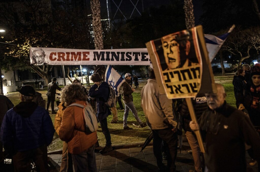 A protester hangs a banner during an anti-government demonstration in Tel Aviv, Isreal, Feb. 17, 2024. (AA Photo)
