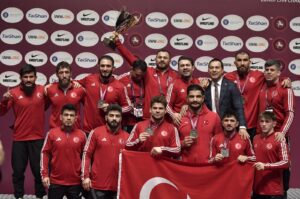 The Turkish wrestling team celebrates with their trophy after dominating the European Championships, Bucharest, Romania, Feb. 18, 2024. (AA Photo)