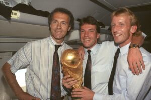 (L-R) Germany national team's Franz Beckenbauer, Lothar Matthaeus and Andreas Brehme pose with the World Cup trophy, Munich, Germany, July 9, 1990. (AP Photo)