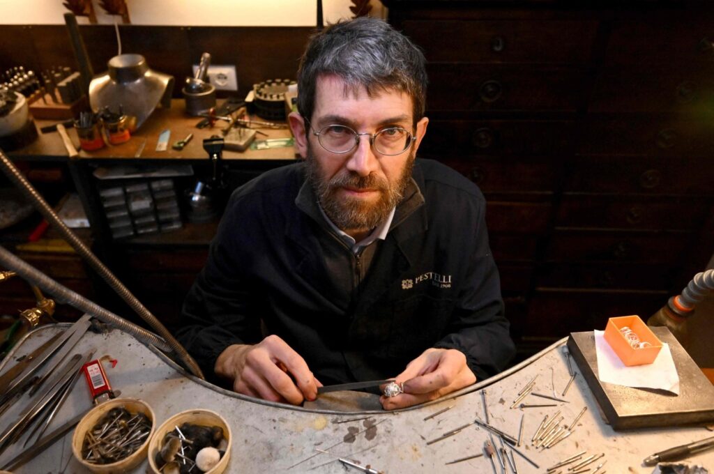 Goldsmith Tommaso Pestelli poses in his new workshop after he was forced to leave the historic one, Florence, Italy, Feb. 15, 2024. (AFP Photo)