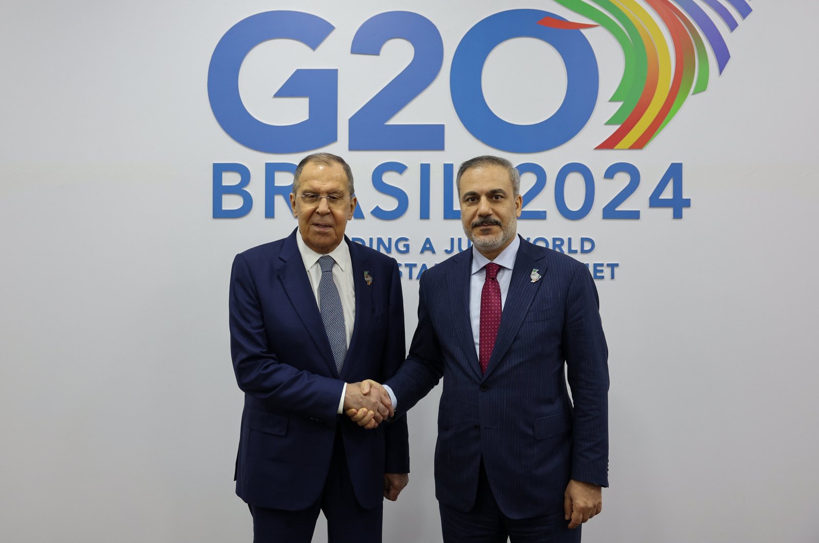 Foreign Minister Hakan Fidan and his Russian counterpart Sergey Lavrov shake hands as they meet at the G-20 Foreign Ministers' meeting in Rio de Janeiro, Brazil, Feb. 22, 2024. (AA Photo)