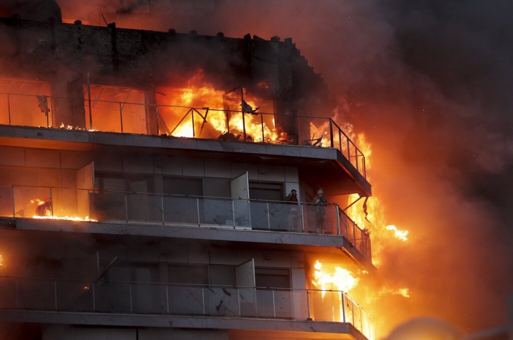 Two people wait to be rescued from a fire at a 14-story residential building in Valencia, Spain, Feb. 22, 2024. (EPA Photo)