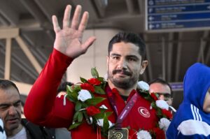 Turkish wrestler Taha Akgül waves at fans at the airport following his 11th European championship title at the 2024 European Wrestling Championships, Istanbul, Türkiye, Feb. 23, 2024. (AA Photo)