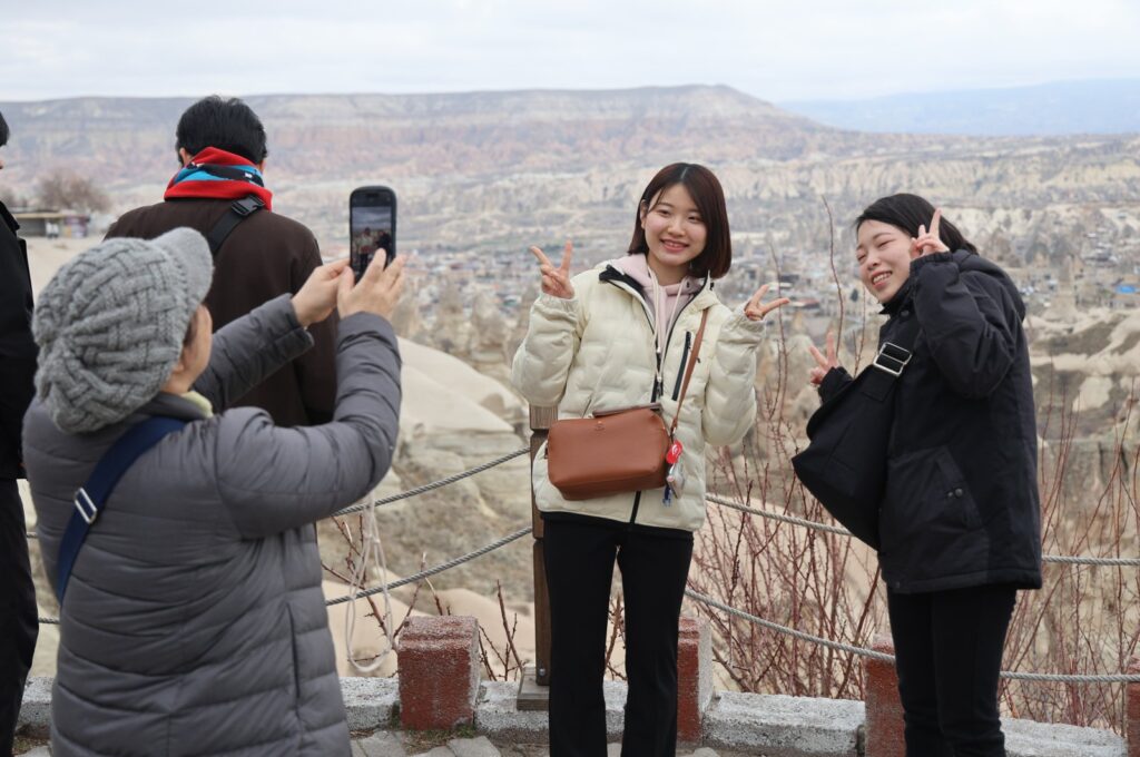 Tourists pose for a photo in Cappadocia, Nevşehir, central Türkiye, Feb. 19, 2024. (IHA Photo)