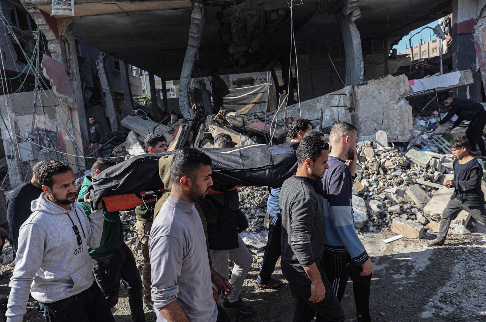 Palestinians carry a body following Israeli bombardment in Rafah, southern Gaza Strip, Palestine, Feb. 24, 2024. (AFP Photo)