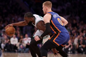 Celtics guard Jaylen Brown (L) controls the ball against Knicks guard Donte DiVincenzo during an NBA game, New York, U.S., Feb 24, 2024. (Reuters Photo)