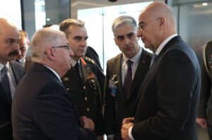 Defense Minister Yaşar Güler (L) chats with Greek counterpart Nikos Dendias on the margins of the NATO Defense Ministers meeting, Brussels, Belgium, Feb. 15, 2024. (IHA Photo)