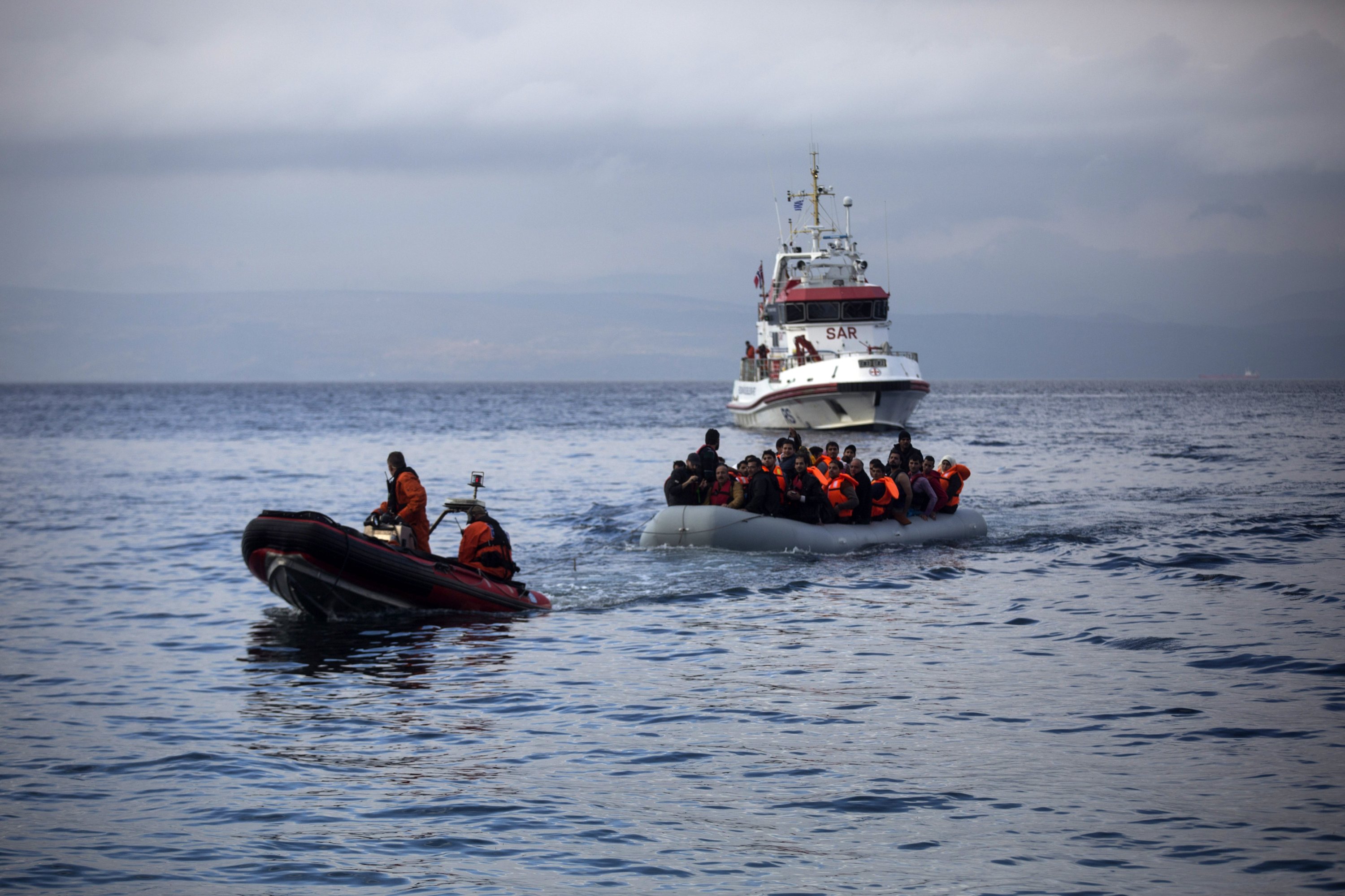 317256 Officers of the European Union border security agency, Frontex, pull a dinghy with migrants to Skala Sikaminias village on the northeastern Greek island of Lesbos, Oct. 21, 2015. (AP Photo)