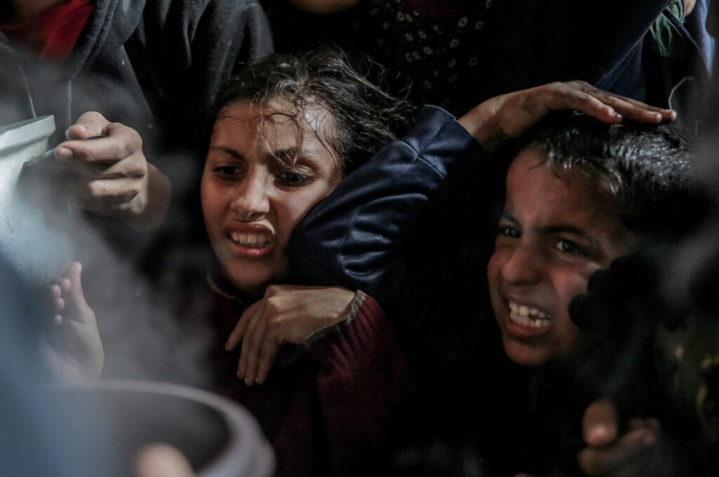 Palestinian children react to collect aid food in Beit Lahia, in the northern Gaza Strip, Palestine, Feb. 26, 2024. (AFP Photo)