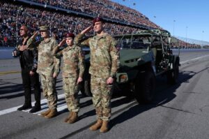 Dwayne "The Rock” Johnson stands with U.S. Army service members during the national anthem before the NASCAR Cup Series Daytona 500, Daytona International Speedway, Daytona Beach, Florida, U.S., Feb. 19, 2024. (AFP Photo)
